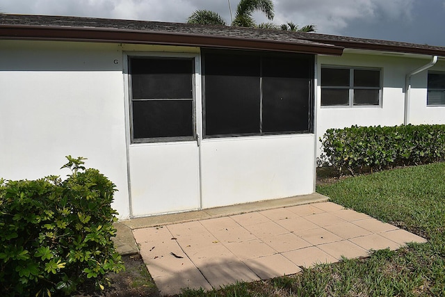 2930 Crosley Dr E Unit G, West Palm Beach, FL 33415 - view of home's exterior with stucco siding and a patio