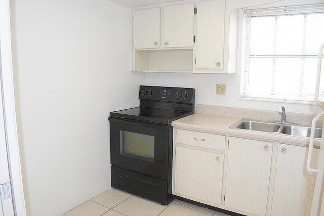 2930 Crosley Dr E Unit G, West Palm Beach, FL 33415 - kitchen with black electric range oven, light tile patterned floors, light countertops, and healthy amount of natural light