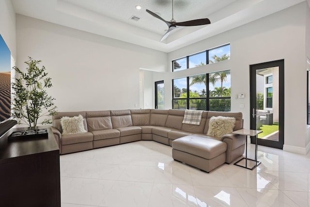 16770 Burlington Bristol Ln, Delray Beach, FL 33446 - living room featuring ceiling fan, light marble finish floors, a high ceiling, a raised ceiling, and recessed lighting