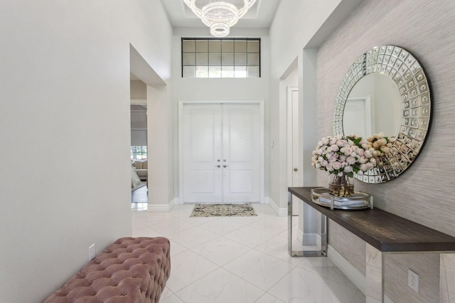 16770 Burlington Bristol Ln, Delray Beach, FL 33446 - entryway featuring a chandelier, a high ceiling, and baseboards