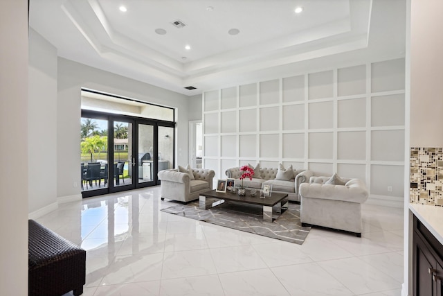 16770 Burlington Bristol Ln, Delray Beach, FL 33446 - living area featuring a tray ceiling, recessed lighting, french doors, a high ceiling, and light marble finish floors