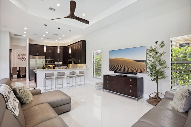 16770 Burlington Bristol Ln, Delray Beach, FL 33446 - living room with light marble finish flooring, a ceiling fan, recessed lighting, and baseboards