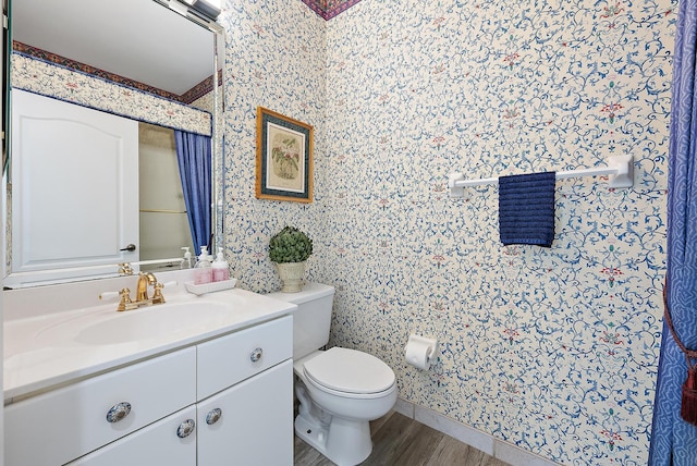 8208 Heritage Club Dr, West Palm Beach, FL 33412 - bathroom featuring wallpapered walls, wood finished floors, toilet, and vanity