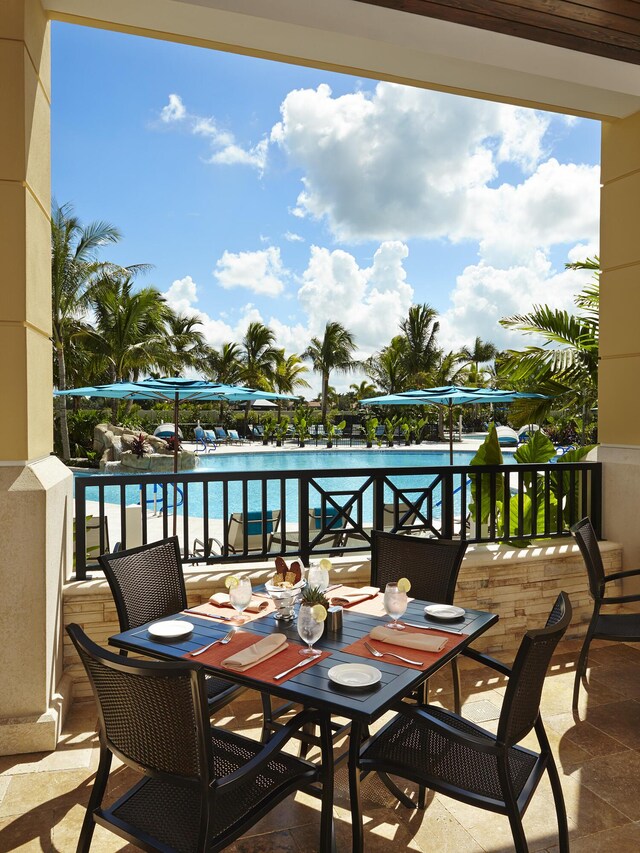 8208 Heritage Club Dr, West Palm Beach, FL 33412 - balcony with view of pool area, a water view, and outdoor dining space