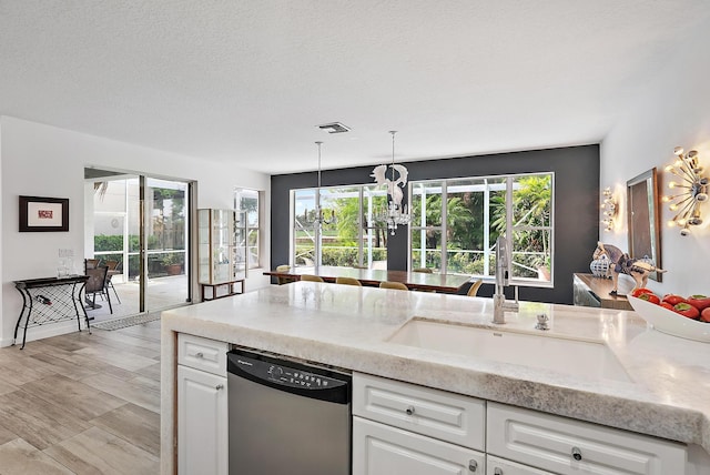 8208 Heritage Club Dr, West Palm Beach, FL 33412 - kitchen with stainless steel dishwasher, a sink, white cabinets, and pendant lighting