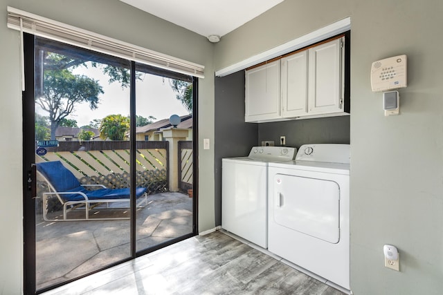 151 Pinto Palm Ct, Royal Palm Beach, FL 33411 - laundry room featuring cabinet space, independent washer and dryer, plenty of natural light, and light wood-type flooring