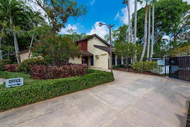 151 Pinto Palm Ct, Royal Palm Beach, FL 33411 - view of front facade with driveway, stucco siding, and a gate