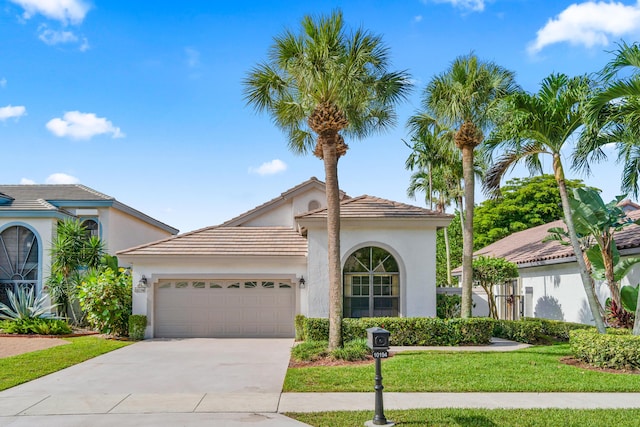 10194 N Lexington Cir, Boynton Beach, FL 33436 - mediterranean / spanish home featuring a garage, driveway, stucco siding, a front lawn, and a tile roof