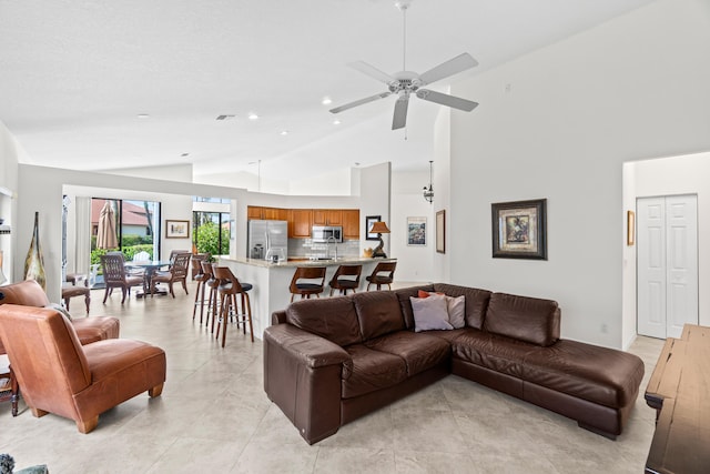 10194 N Lexington Cir, Boynton Beach, FL 33436 - living area with light tile patterned floors, ceiling fan, recessed lighting, and high vaulted ceiling