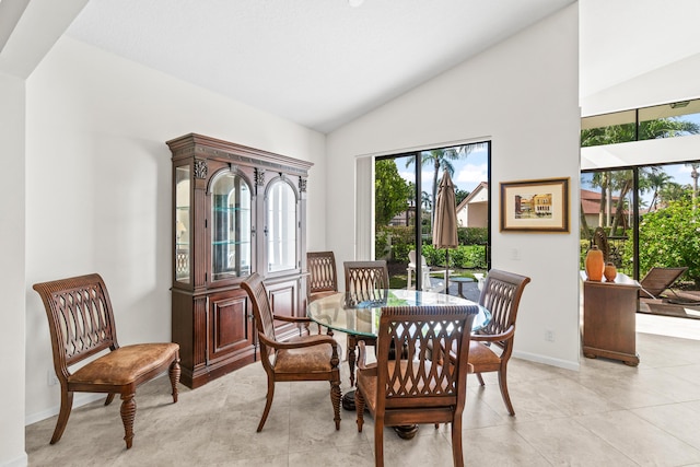 10194 N Lexington Cir, Boynton Beach, FL 33436 - dining area with vaulted ceiling, baseboards, and light tile patterned floors