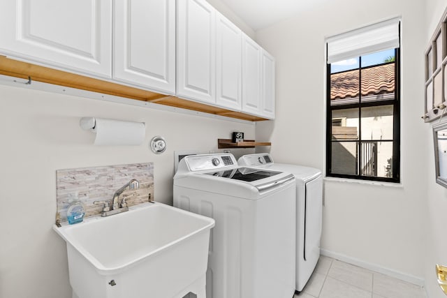 10194 N Lexington Cir, Boynton Beach, FL 33436 - washroom with cabinet space, independent washer and dryer, light tile patterned floors, and baseboards