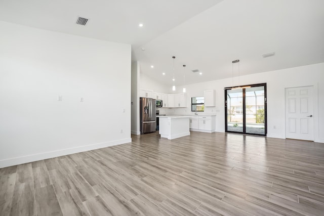 2458 NW 9th Ter, Cape Coral, FL 33993 - unfurnished living room with high vaulted ceiling, baseboards, light wood-style flooring, and recessed lighting