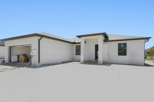 2458 NW 9th Ter, Cape Coral, FL 33993 - view of front of property with stucco siding, an attached garage, and roof with shingles