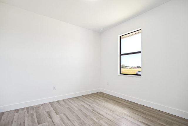 2458 NW 9th Ter, Cape Coral, FL 33993 - unfurnished room with baseboards and light wood finished floors