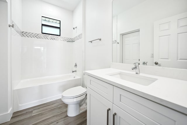 2458 NW 9th Ter, Cape Coral, FL 33993 - full bath featuring toilet, vanity, shower / bathtub combination, and wood finished floors