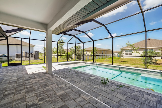 2458 NW 9th Ter, Cape Coral, FL 33993 - swimming pool with a patio area, a lawn, glass enclosure, and a residential view