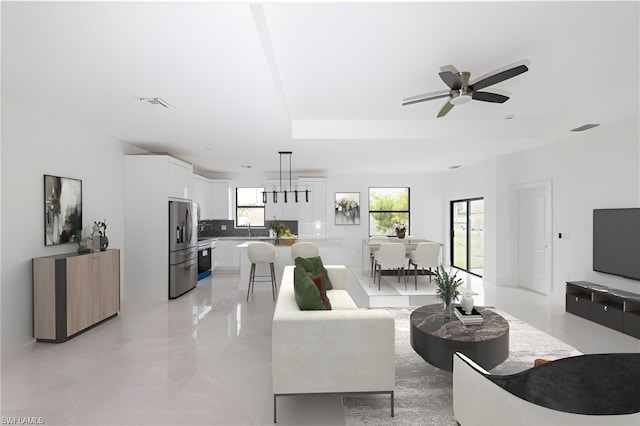 2458 NW 9th Ter, Cape Coral, FL 33993 - living area featuring ceiling fan and a raised ceiling