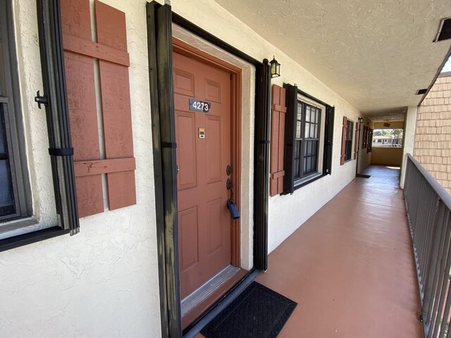 4273 Oak Terrace Dr, Greenacres, FL 33463 - property entrance featuring stucco siding and a porch