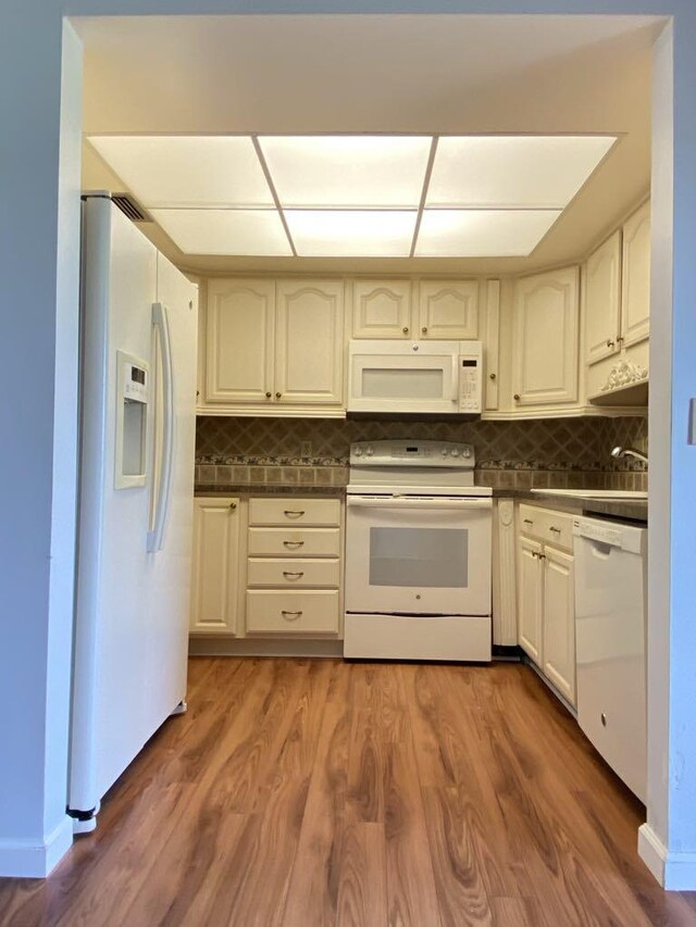 4273 Oak Terrace Dr, Greenacres, FL 33463 - kitchen with white appliances, dark countertops, backsplash, and dark wood-type flooring