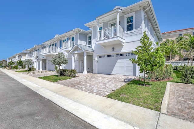 156 Seagrape Ln, Tequesta, FL 33469 - multi unit property featuring a garage, a balcony, driveway, and stucco siding