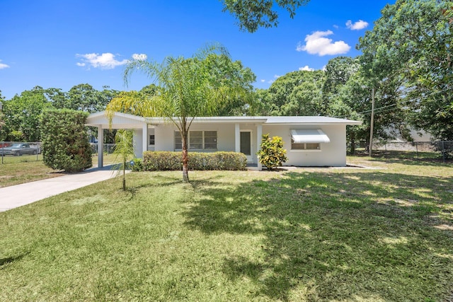 903 S 27th St, Fort Pierce, FL 34947 - view of front facade featuring stucco siding, driveway, and an attached carport