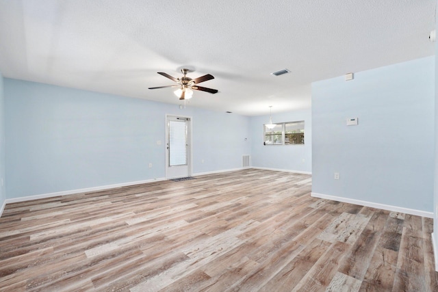 903 S 27th St, Fort Pierce, FL 34947 - spare room with light wood-style flooring, ceiling fan, baseboards, and a textured ceiling