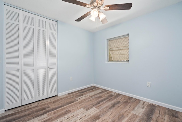 903 S 27th St, Fort Pierce, FL 34947 - unfurnished bedroom featuring a closet, wood finished floors, baseboards, and ceiling fan