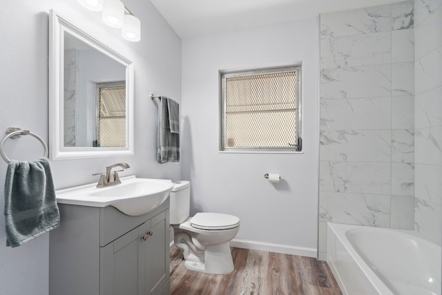 903 S 27th St, Fort Pierce, FL 34947 - full bath with vanity, toilet, wood finished floors, baseboards, and bathtub / shower combination