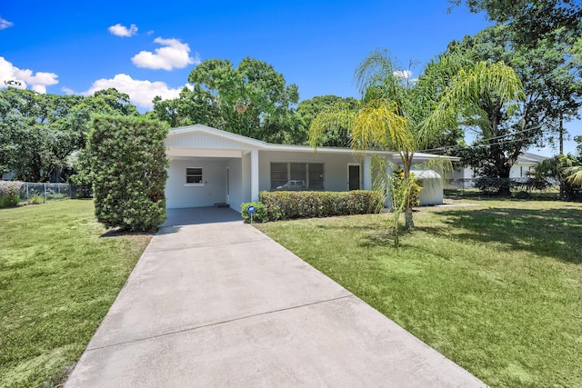 903 S 27th St, Fort Pierce, FL 34947 - view of front of property with concrete driveway, an attached carport, and stucco siding