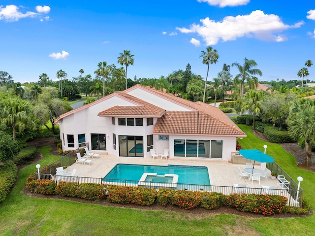 4402 SW Dundee Ct, Palm City, FL 34990 - rear view of property featuring a patio, a tiled roof, a pool with connected hot tub, stucco siding, and view of scattered trees