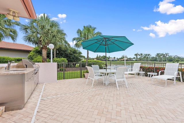 4402 SW Dundee Ct, Palm City, FL 34990 - view of patio / terrace featuring a sink and outdoor dining space