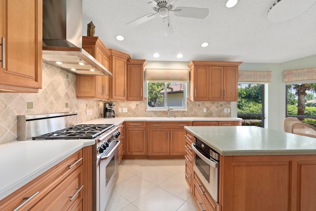 4402 SW Dundee Ct, Palm City, FL 34990 - kitchen with wall chimney exhaust hood, appliances with stainless steel finishes, a sink, light countertops, and tasteful backsplash