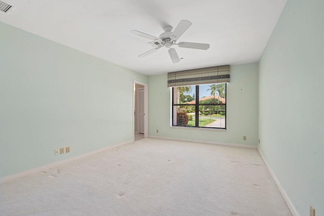 4402 SW Dundee Ct, Palm City, FL 34990 - spare room with light carpet, baseboards, and ceiling fan