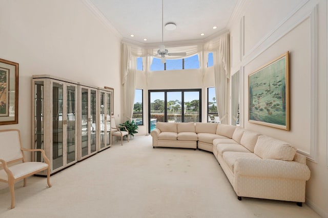 4402 SW Dundee Ct, Palm City, FL 34990 - carpeted living room with crown molding, a water view, a high ceiling, recessed lighting, and baseboards