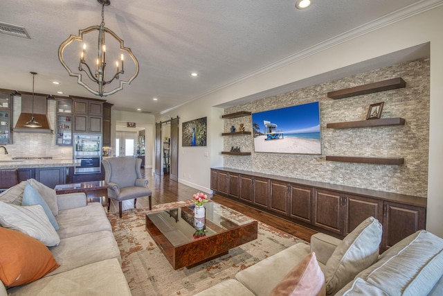4858 Marginada Way, Lake Worth, FL 33467 - living area with wood finished floors, a barn door, a chandelier, recessed lighting, and ornamental molding