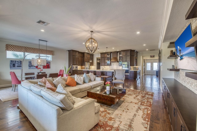 4858 Marginada Way, Lake Worth, FL 33467 - living room with a chandelier, dark wood-style flooring, recessed lighting, a textured ceiling, and baseboards