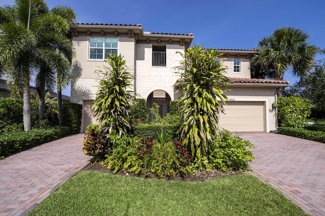 4858 Marginada Way, Lake Worth, FL 33467 - mediterranean / spanish-style house with a garage, decorative driveway, and stucco siding