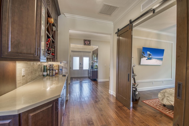 4858 Marginada Way, Lake Worth, FL 33467 - corridor featuring dark wood finished floors, a barn door, crown molding, and baseboards