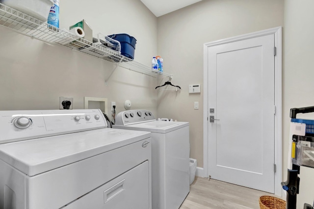 12522 Via Ravenna, Boynton Beach, FL 33436 - washroom with separate washer and dryer, light wood finished floors, and baseboards