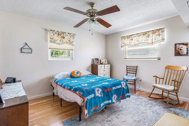 4971 N Kay St, Palm Beach Gardens, FL 33418 - bedroom with wood finished floors, baseboards, a textured ceiling, and ceiling fan