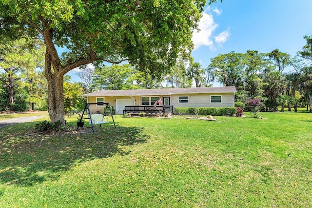 4971 N Kay St, Palm Beach Gardens, FL 33418 - rear view of house featuring a garage, a yard, and a deck
