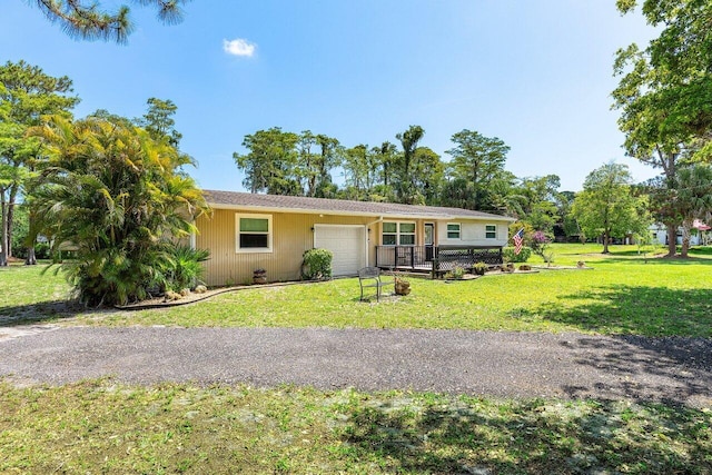 4971 N Kay St, Palm Beach Gardens, FL 33418 - ranch-style home featuring a garage, a front lawn, and driveway