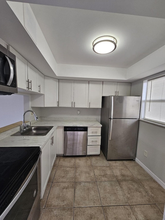 2800 NW 56th Ave Unit C306, Lauderhill, FL 33313 - kitchen with appliances with stainless steel finishes, a sink, white cabinetry, and light countertops