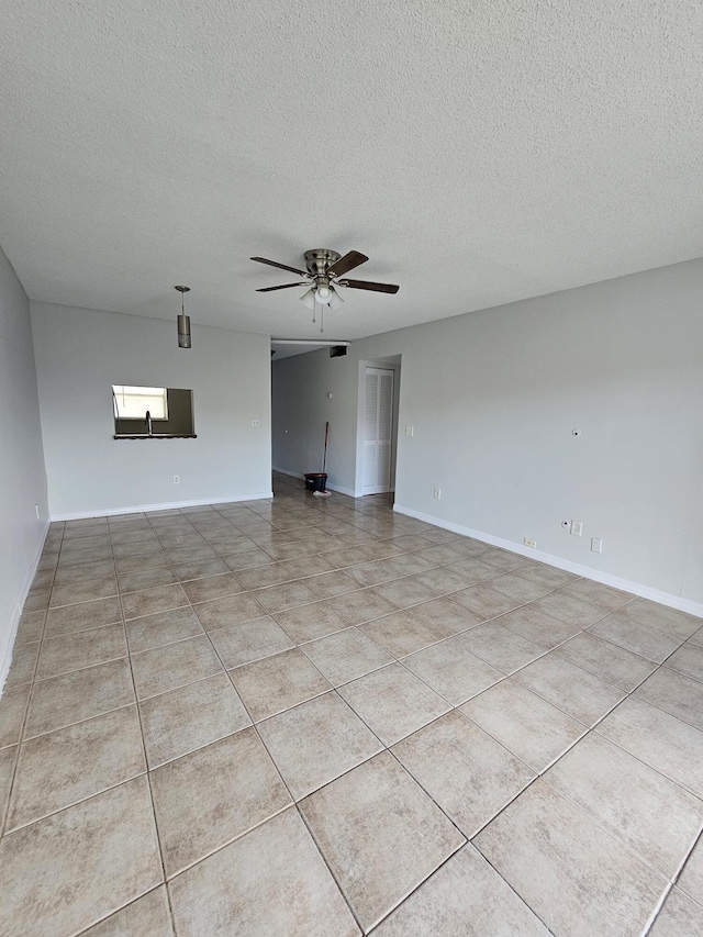 2800 NW 56th Ave Unit C306, Lauderhill, FL 33313 - empty room with ceiling fan, a textured ceiling, light tile patterned floors, and baseboards