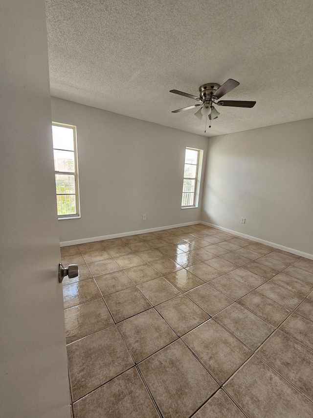 2800 NW 56th Ave Unit C306, Lauderhill, FL 33313 - tiled empty room featuring a textured ceiling, ceiling fan, and baseboards