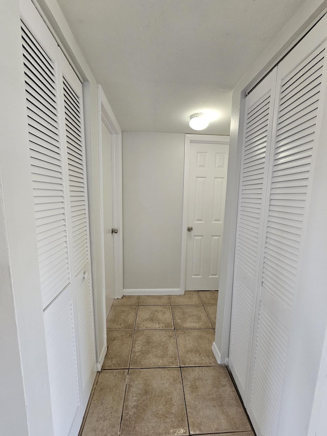 2800 NW 56th Ave Unit C306, Lauderhill, FL 33313 - hall featuring light tile patterned floors and baseboards