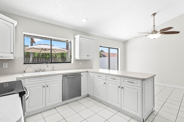 9496 Majestic Way, Boynton Beach, FL 33437 - kitchen with stainless steel dishwasher, electric range, a sink, a peninsula, and a textured ceiling