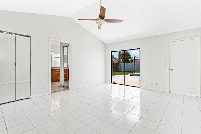 9496 Majestic Way, Boynton Beach, FL 33437 - unfurnished bedroom with access to outside, vaulted ceiling, light tile patterned floors, and baseboards