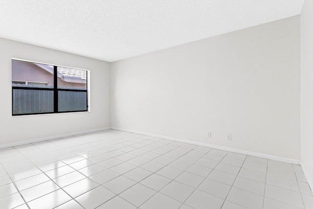 9496 Majestic Way, Boynton Beach, FL 33437 - empty room with a textured ceiling, light tile patterned floors, and baseboards