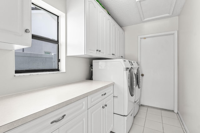 9496 Majestic Way, Boynton Beach, FL 33437 - washroom with washer and clothes dryer, cabinet space, light tile patterned flooring, baseboards, and a textured ceiling